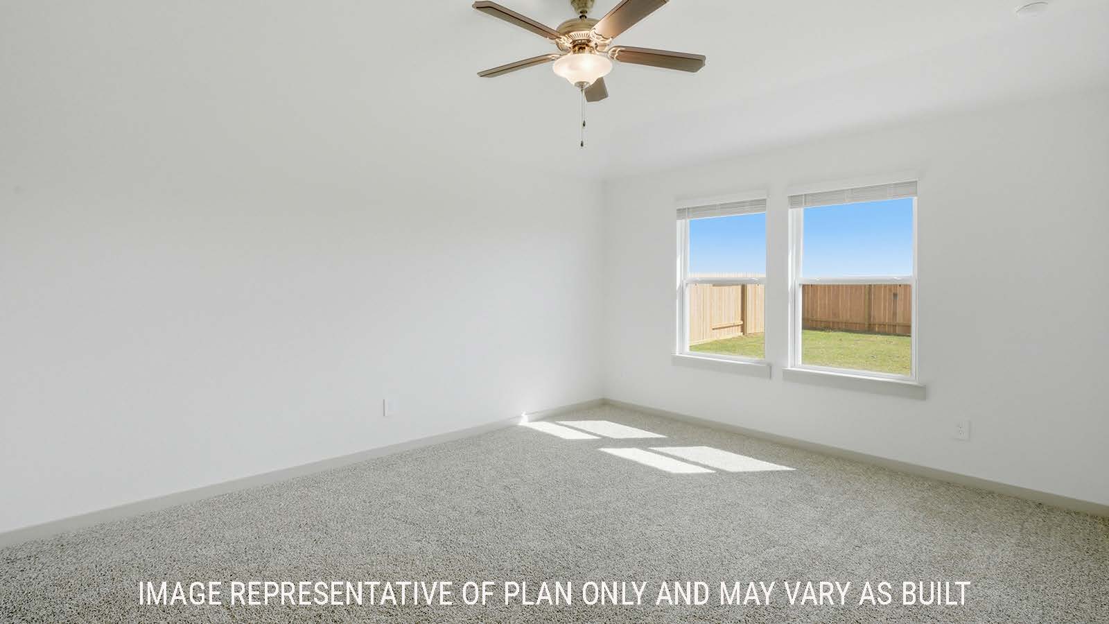 Texas Cali primary bedroom with carpeted flooring and windows for natural lighting.