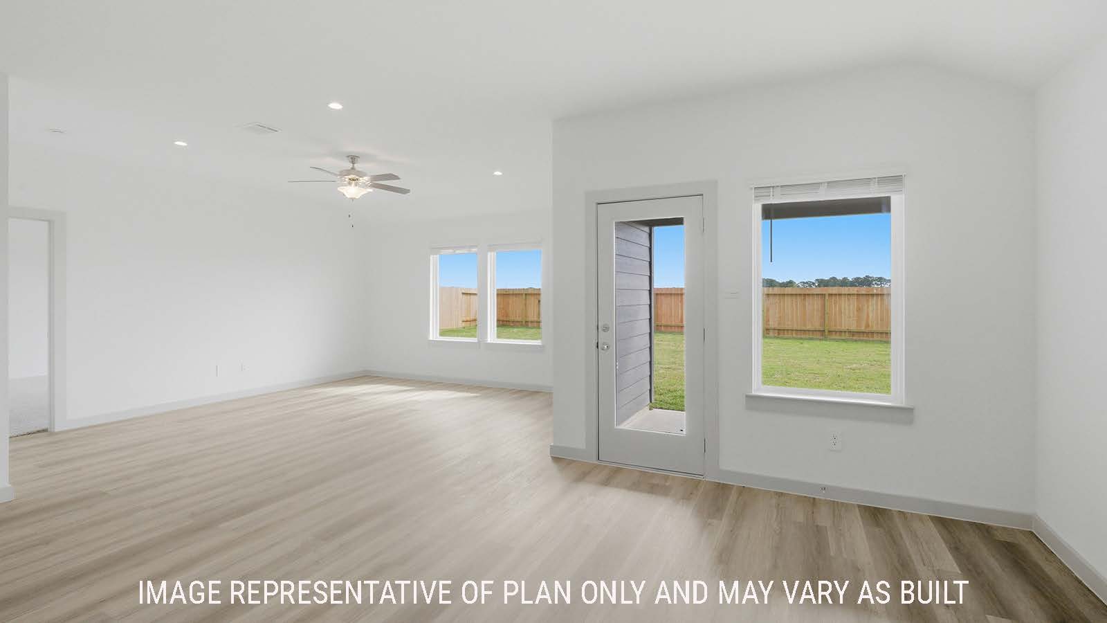 Texas Cali living room with vinyl plank flooring and windows for natural lighting.