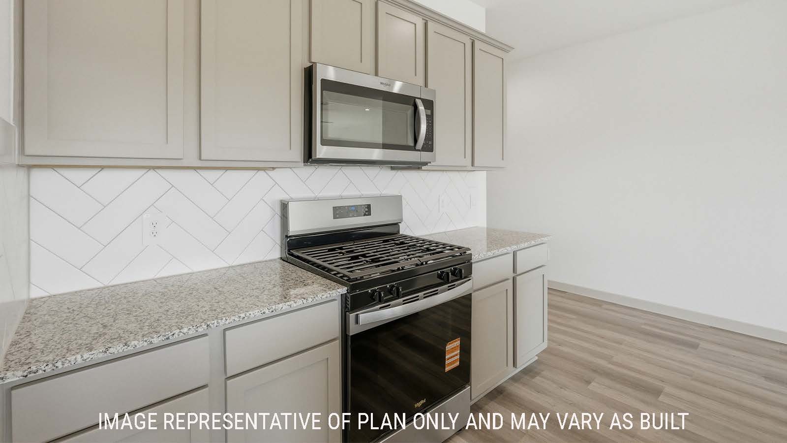 Texas Cali kitchen with light cabinets and granite countertops with stainless steel appliances.