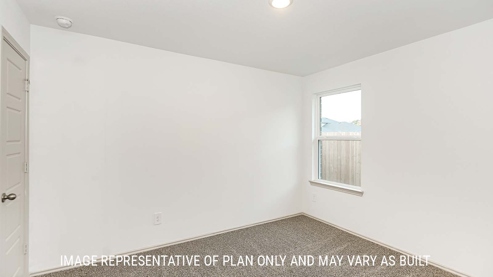 Lakeway secondary bedroom with carpeted flooring and window for natural lighting.
