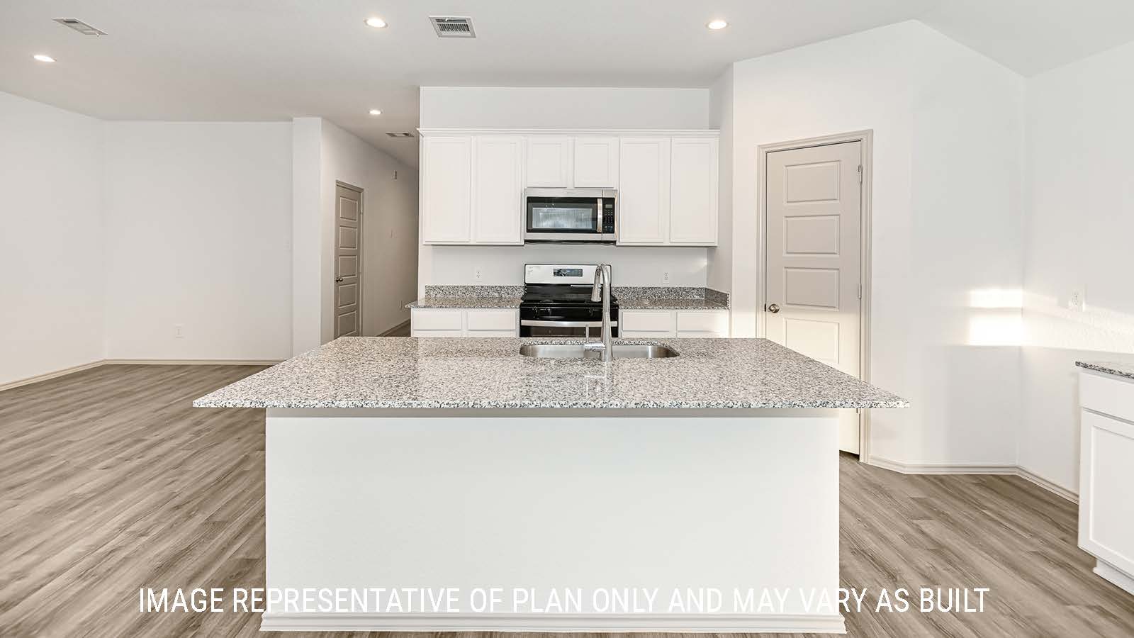 Lakeway kitchen with kitchen island and white cabinets with granite countertops.