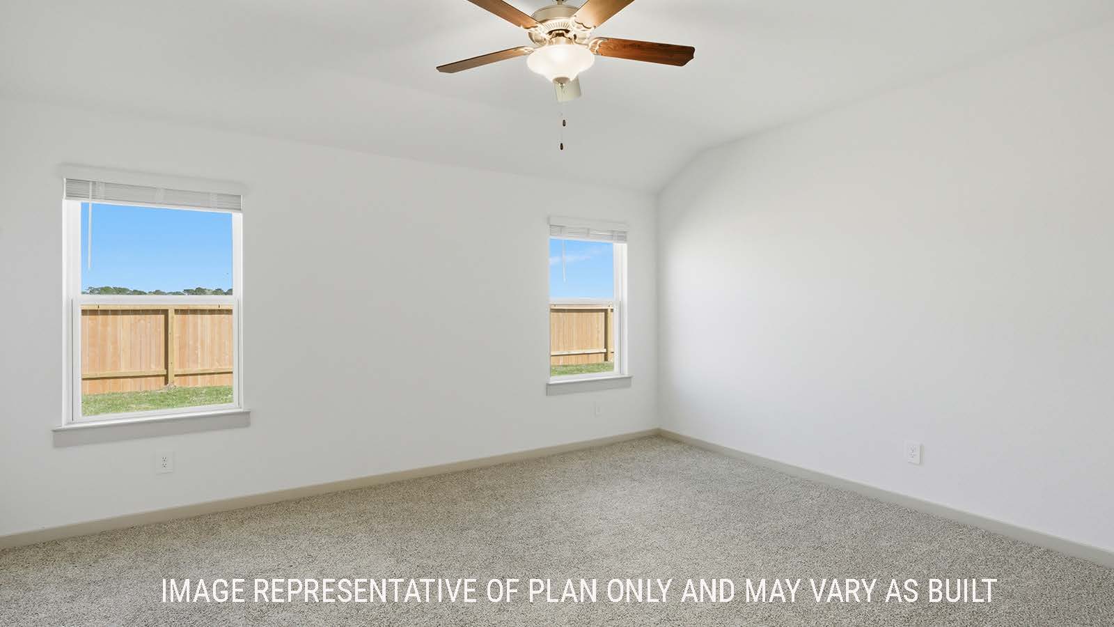 Lakeway primary bedroom with carpeted flooring and windows for natural lighting.