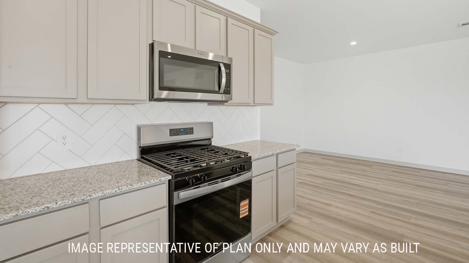 Lakeway kitchen with granite countertops and light cabinets with view of open concept dining room.