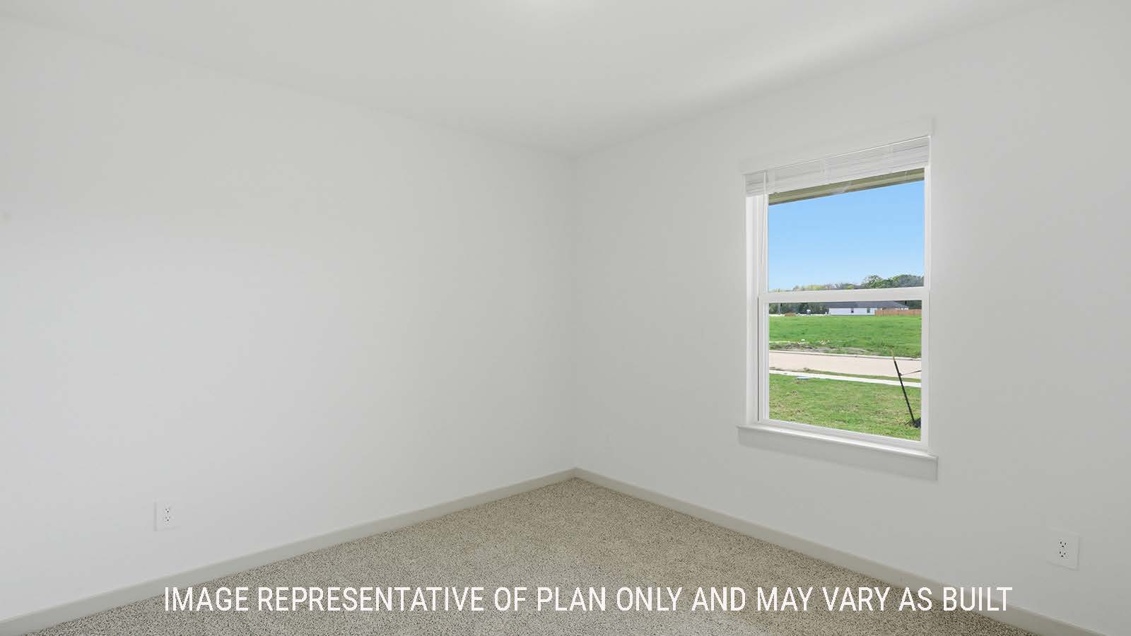 Lakeway secondary bedroom with carpeted flooring and window for natural lighting.