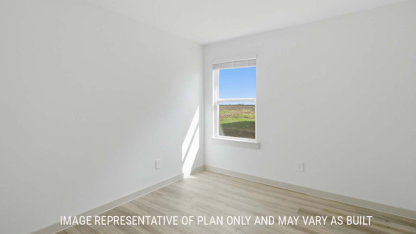 Lakeway study with vinyl plank flooring and window for natural lighting.