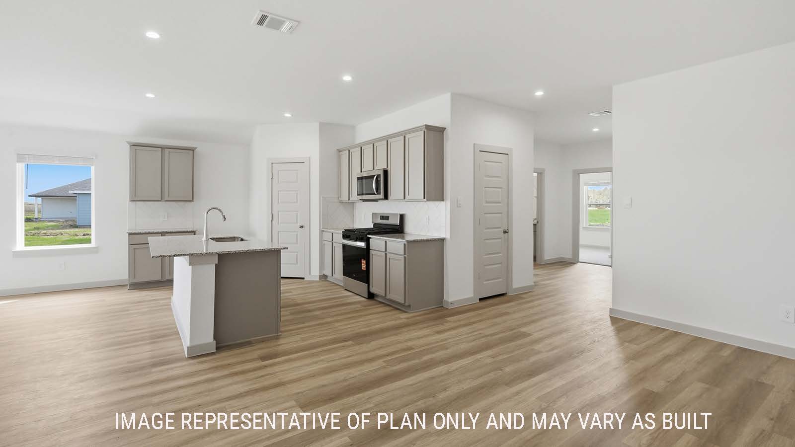 Lakeway dining room with view of open concept kitchen and front entry way.