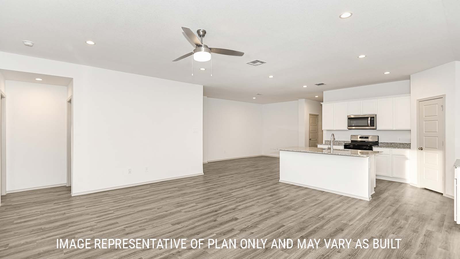 Lakeway living room with vinyl plank flooring and view of kitchen.