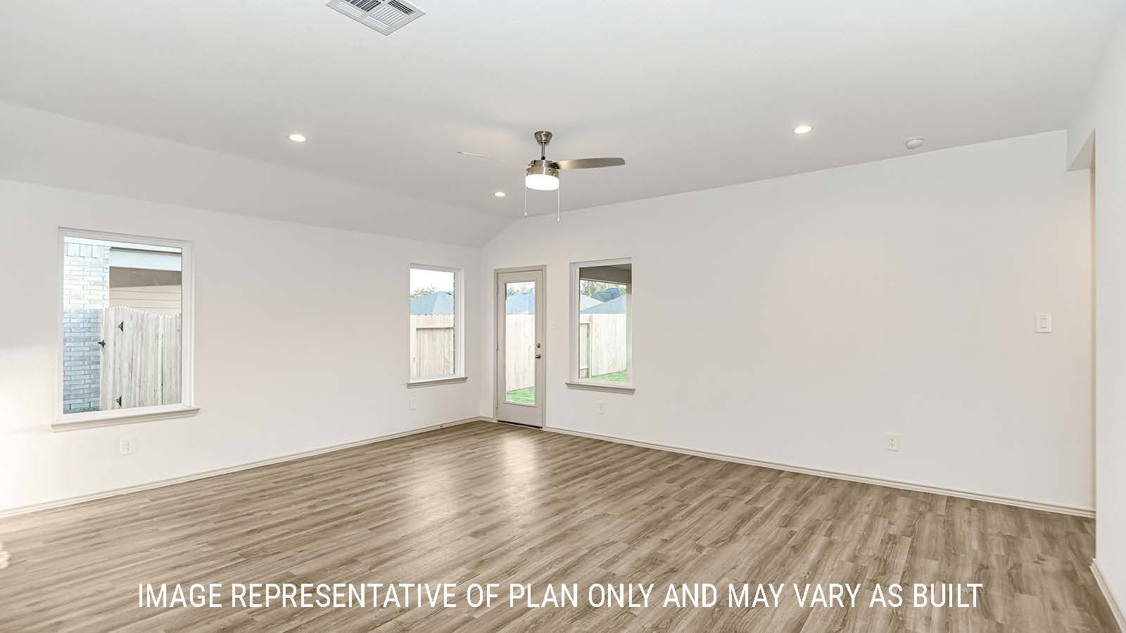 Lakeway living room with vinyl plank flooring with view of back door to backyard.