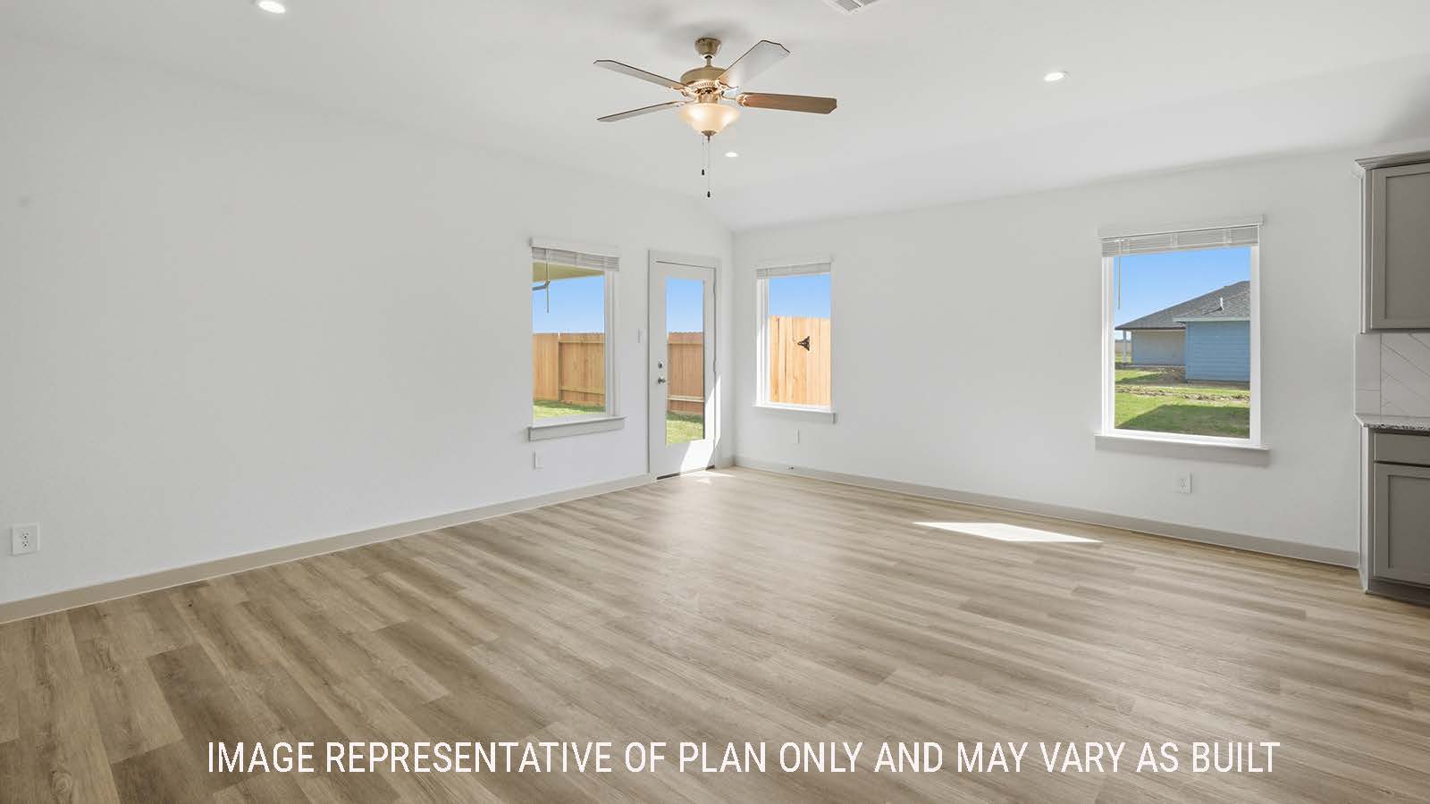 Lakeway living room with vinyl plank flooring with widows for natural lighting and view of back yard.