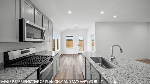 Baxtor kitchen with stainless appliances and kitchen island.