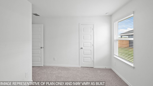 Harris secondary bedroom with carpet and window.