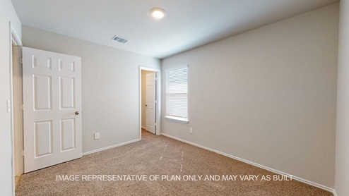 Bellvue secondary bedroom with carpet flooring and window.