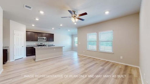 Bellvue living room with vinyl plank flooring and windows for natural lighting.