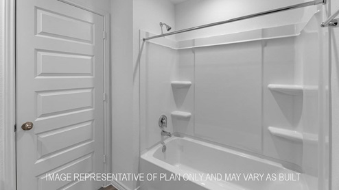 Denton secondary bathroom with shower and tub combo.
