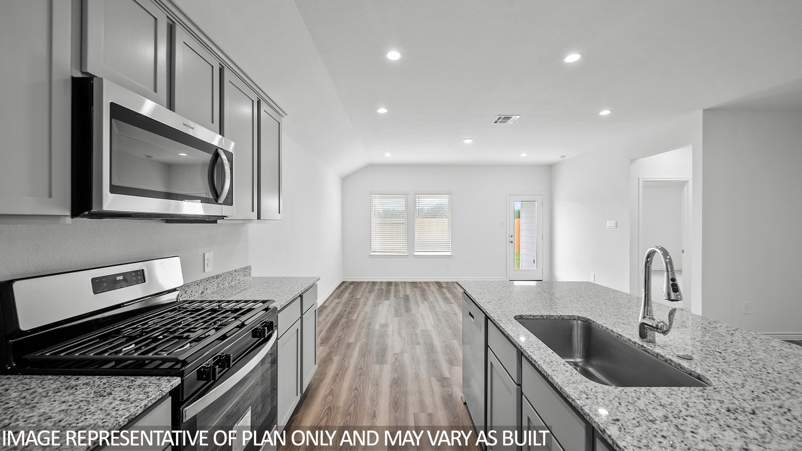 Harris kitchen with spacious island and gray cabinets, granite countertops and vinyl plank flooring.