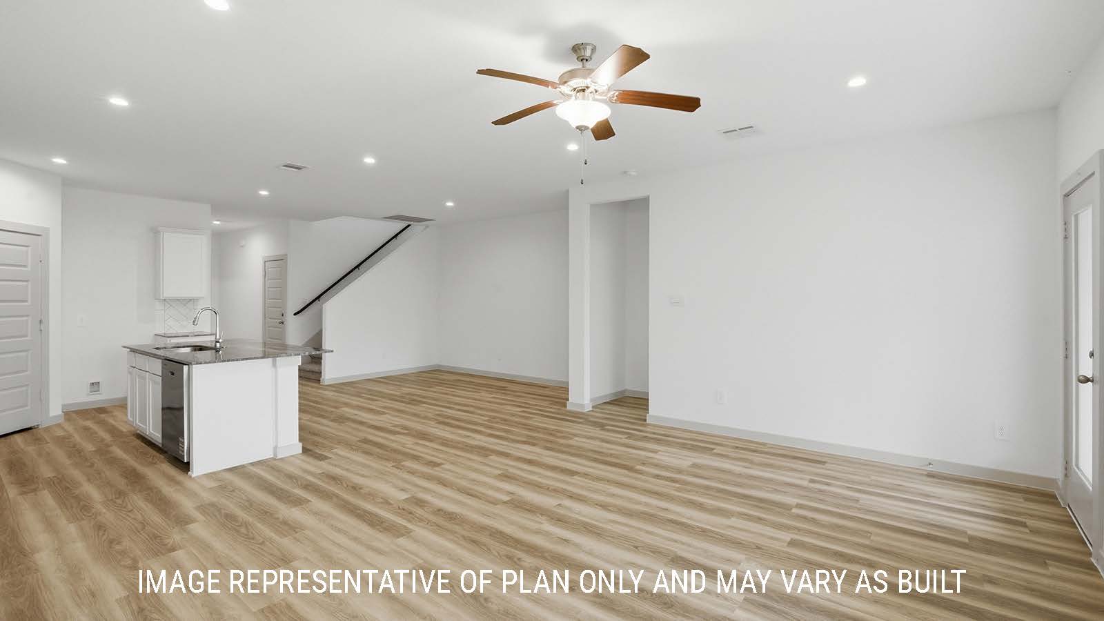 Mitchell living room with vinyl plank flooring and view of open concept kitchen and dining room.