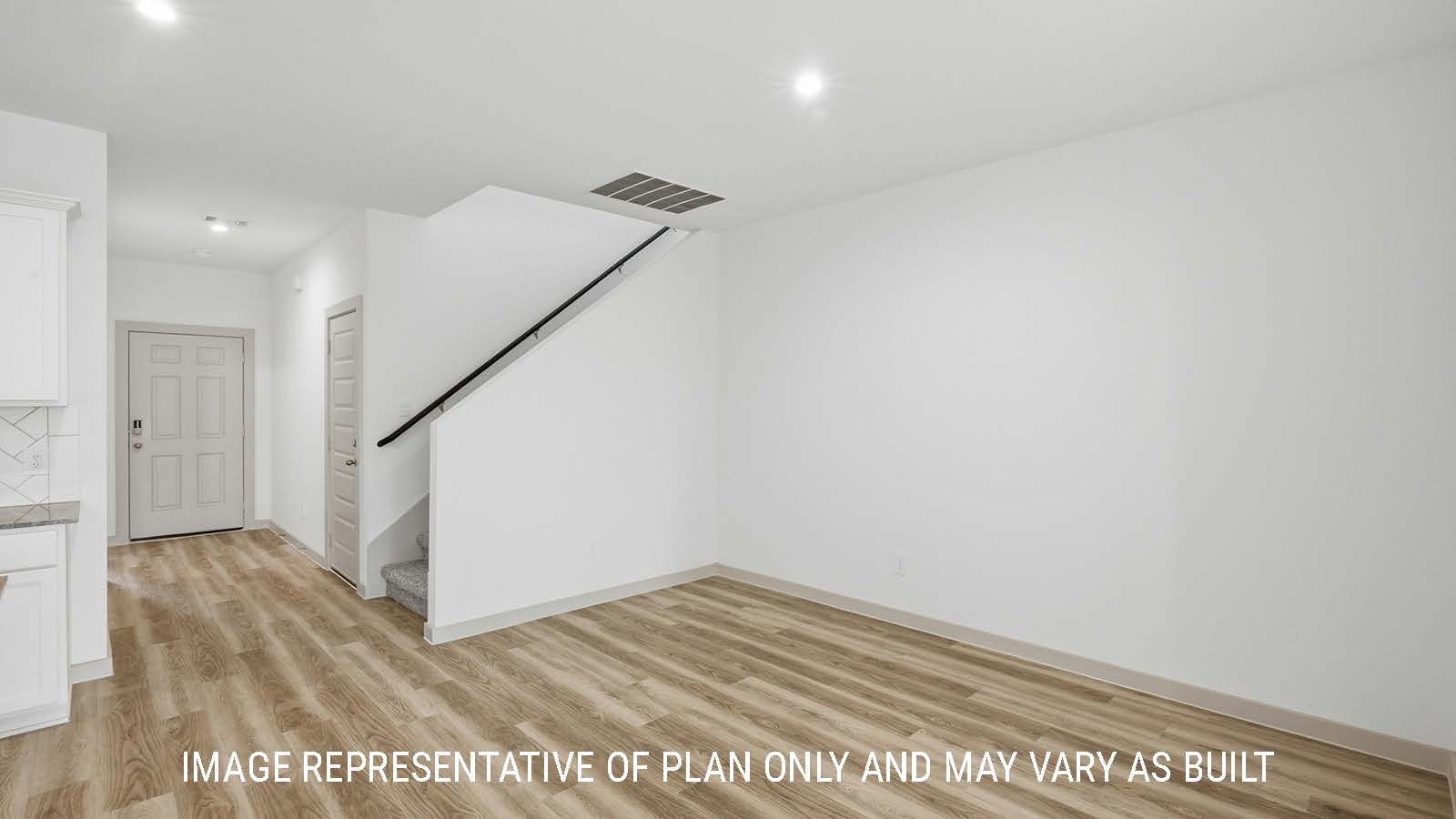 Mitchell dining room with vinyl plank flooring and view of front entry way and stairs.