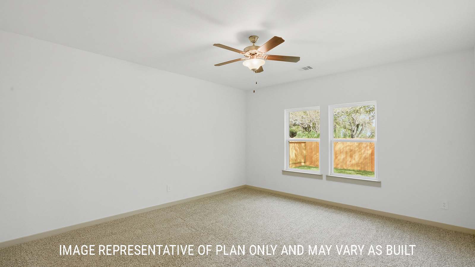 Mitchell primary bedroom with carpeted flooring and windows for natural lighting.