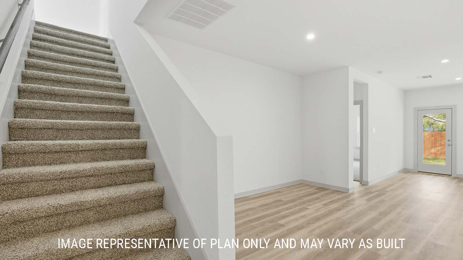 Mitchell dining room with vinyl plank flooring and view of primary bedroom and stairs.