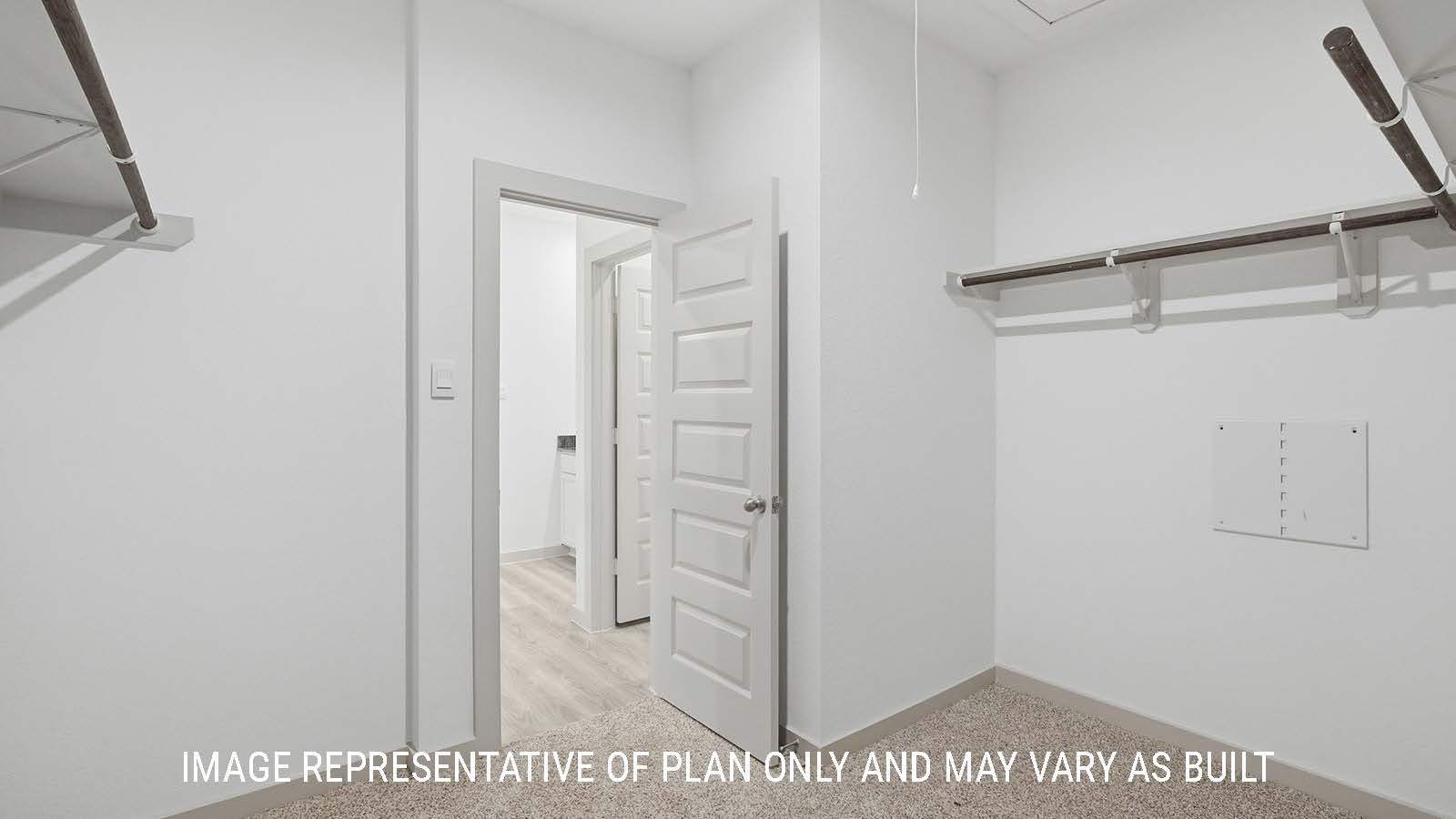 Mitchell primary bedroom closet with carpeted flooring and shelving for storage.