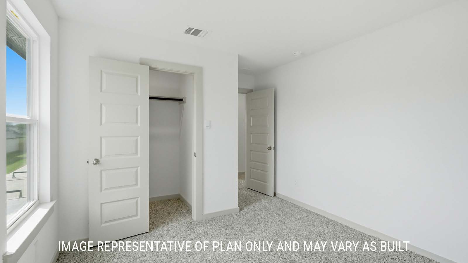 Mitchell secondary bedroom with carpeted flooring and window for natural lighting.