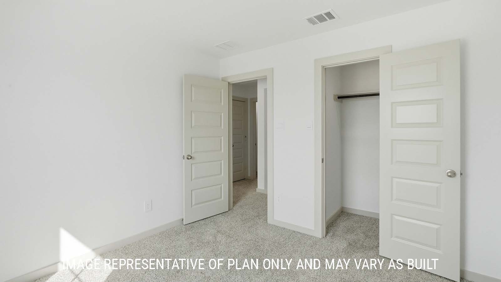 Mitchell secondary bedroom with carpeted flooring and closet with view of hallway to game room.