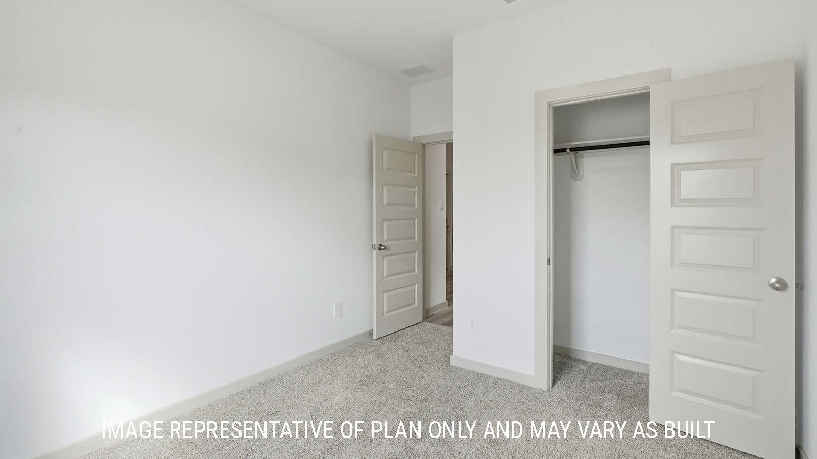 Mitchell secondary bedroom with carpeted flooring and closet with view of hallway to game room.