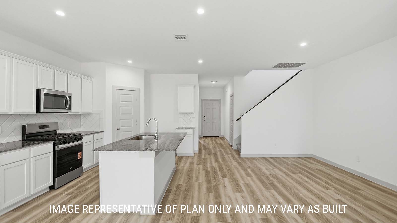 Mitchell kitchen with light cabinets and dark granite countertops with view of open concept dining room.