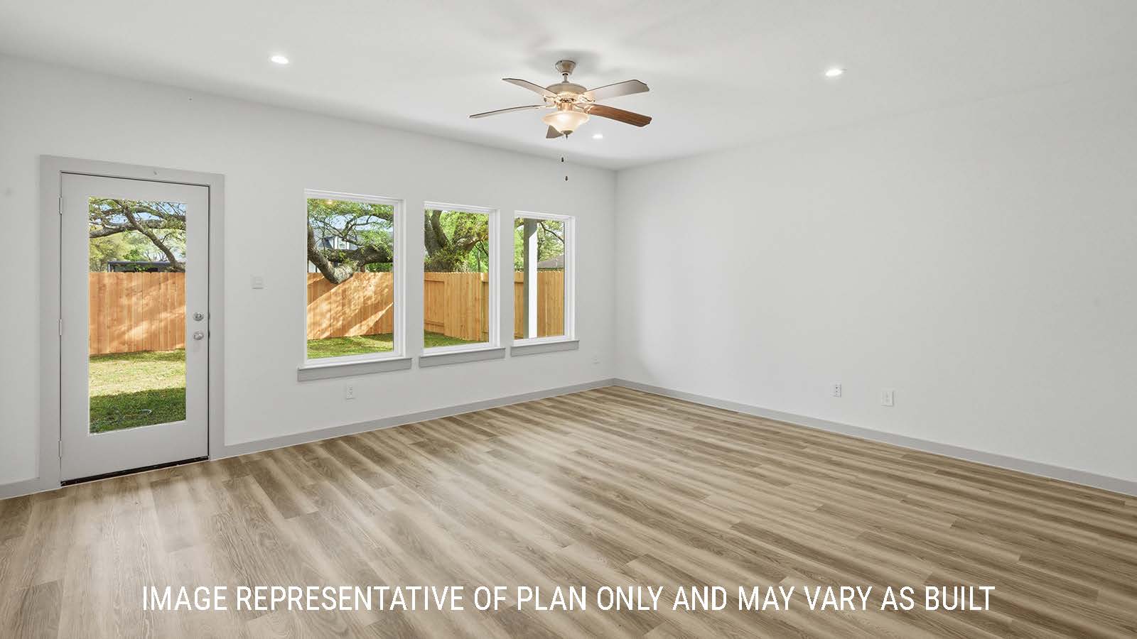Mitchell living room with vinyl plank flooring and windows for natural lighting with view of back yard.