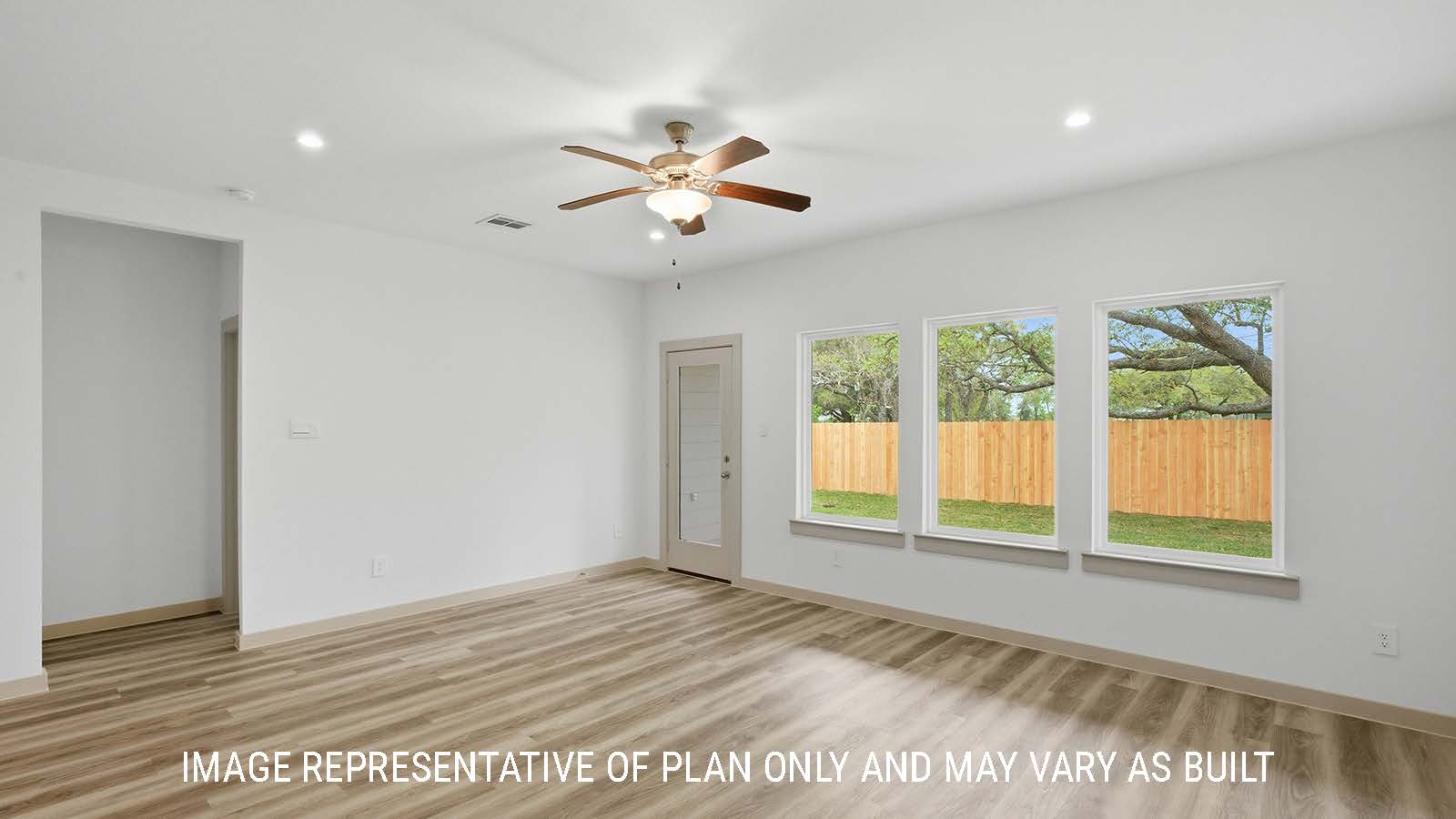 Mitchell living room with vinyl plank flooring and windows for natural lighting with view of primary bedroom.