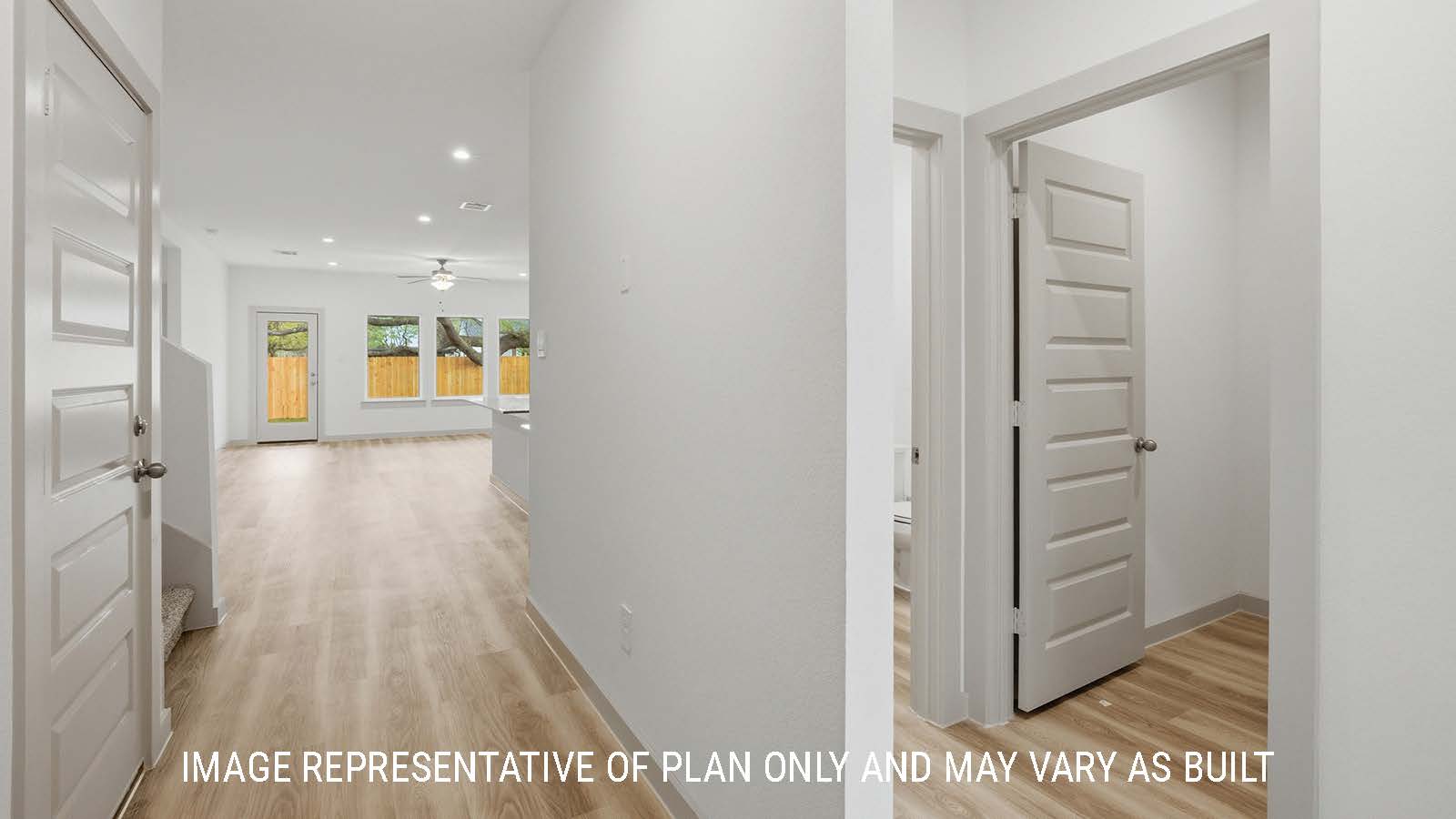 Mitchell entry way with vinyl plank flooring and view of open concept dining room and living room.