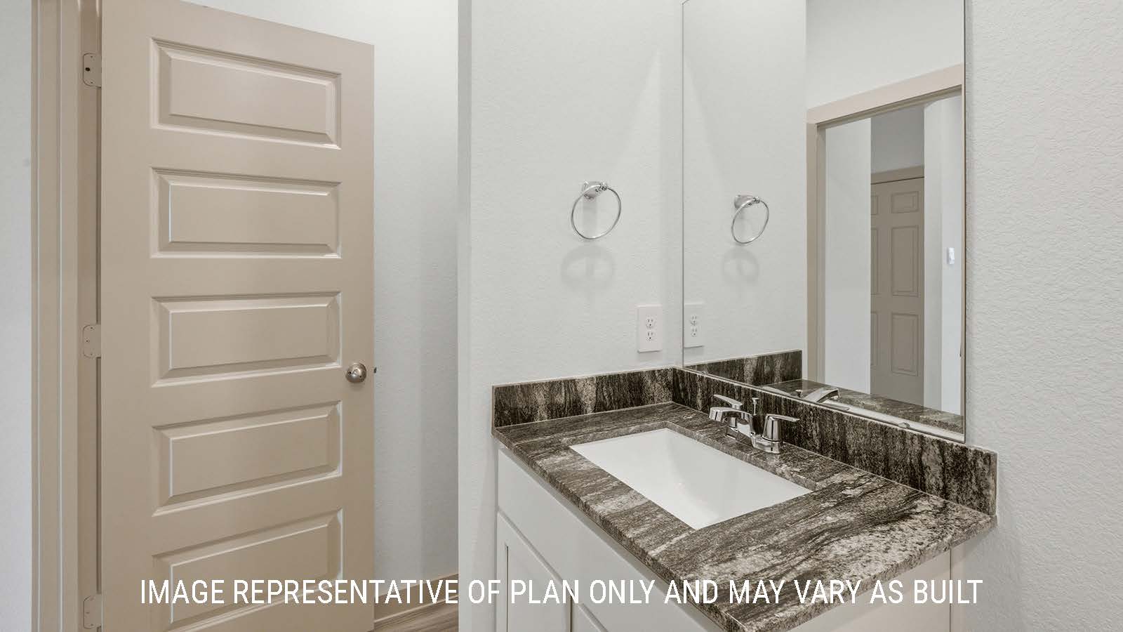 Mitchell secondary bathroom with shelving for storage and vanity sink.