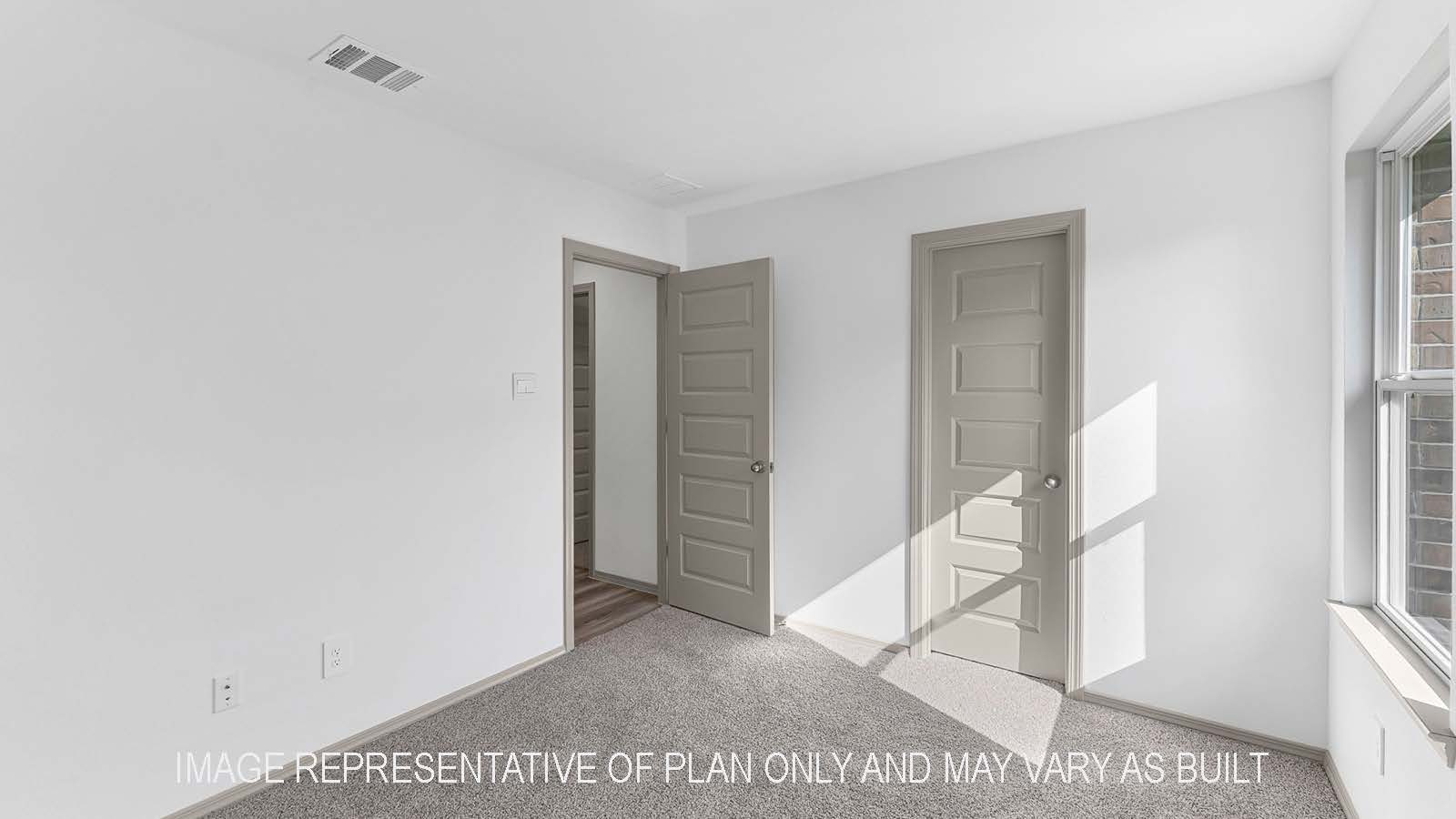 Bellvue secondary bedroom with carpet flooring and window.