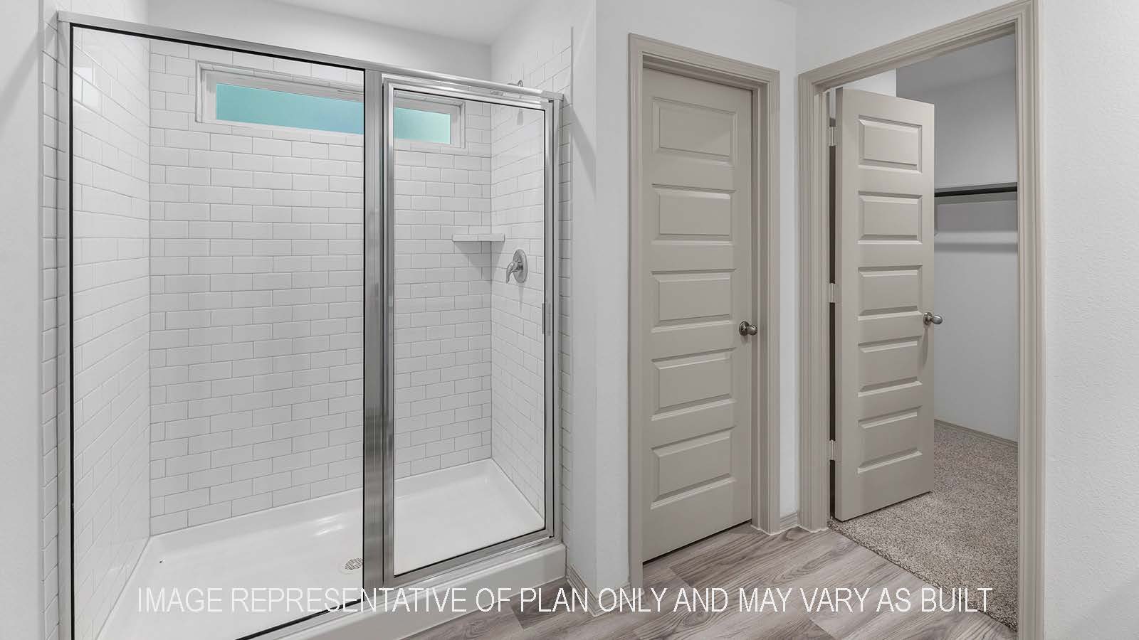 Bellvue primary bathroom with walk-in shower and view of walk-in closet