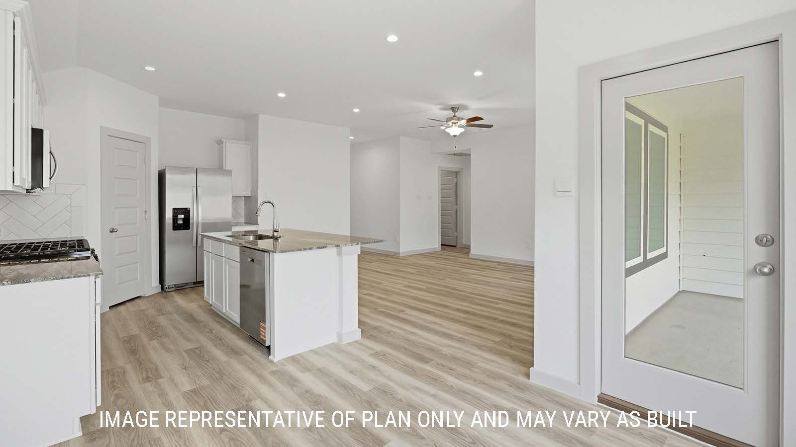 Bellvue dining room with vinyl plank flooring and view of open concept kitchen and living room.