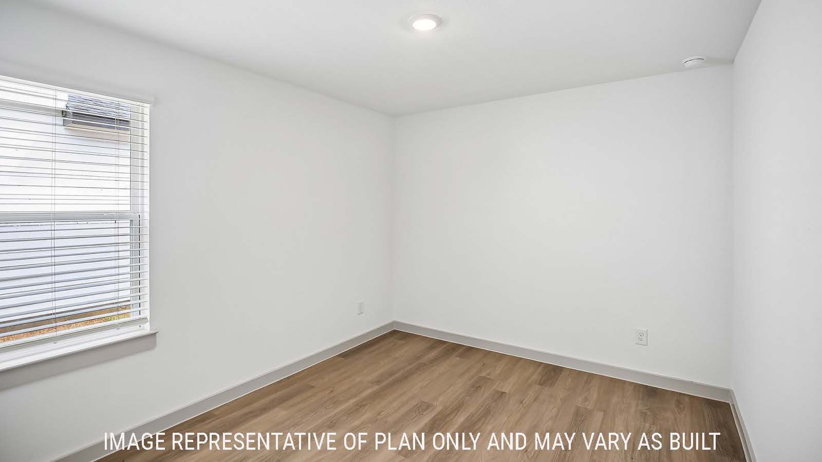 Denton secondary bedroom with vinyl plank flooring and window for natural lighting.