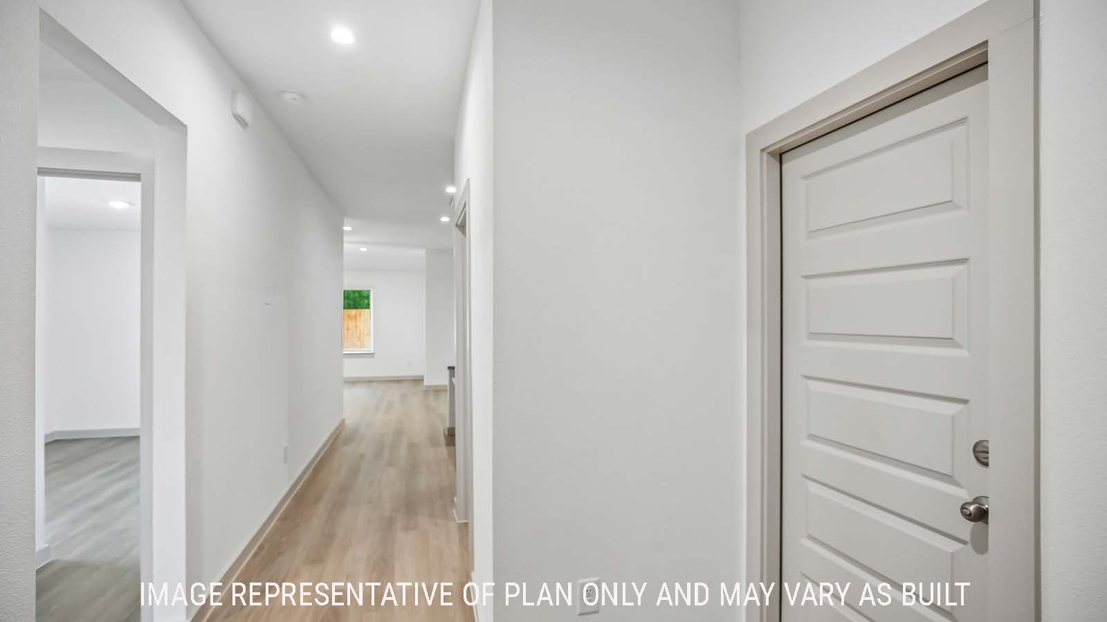 Denton entry way hallway with view of secondary bedrooms and open concept kitchen.