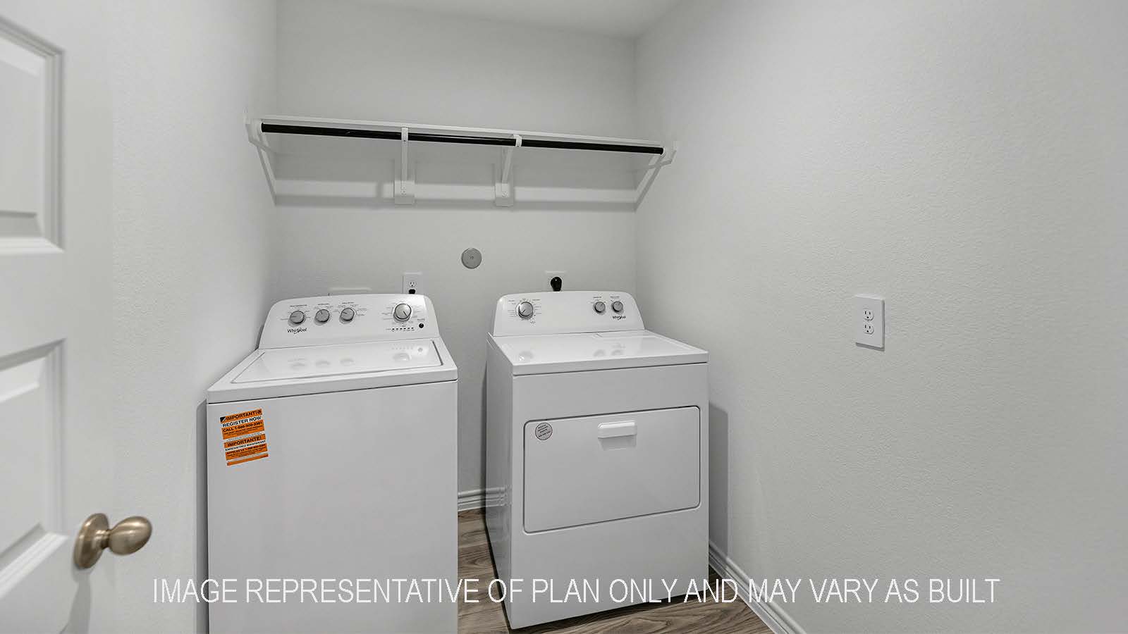 Denton utility room with washer and dryer and storage shelving.