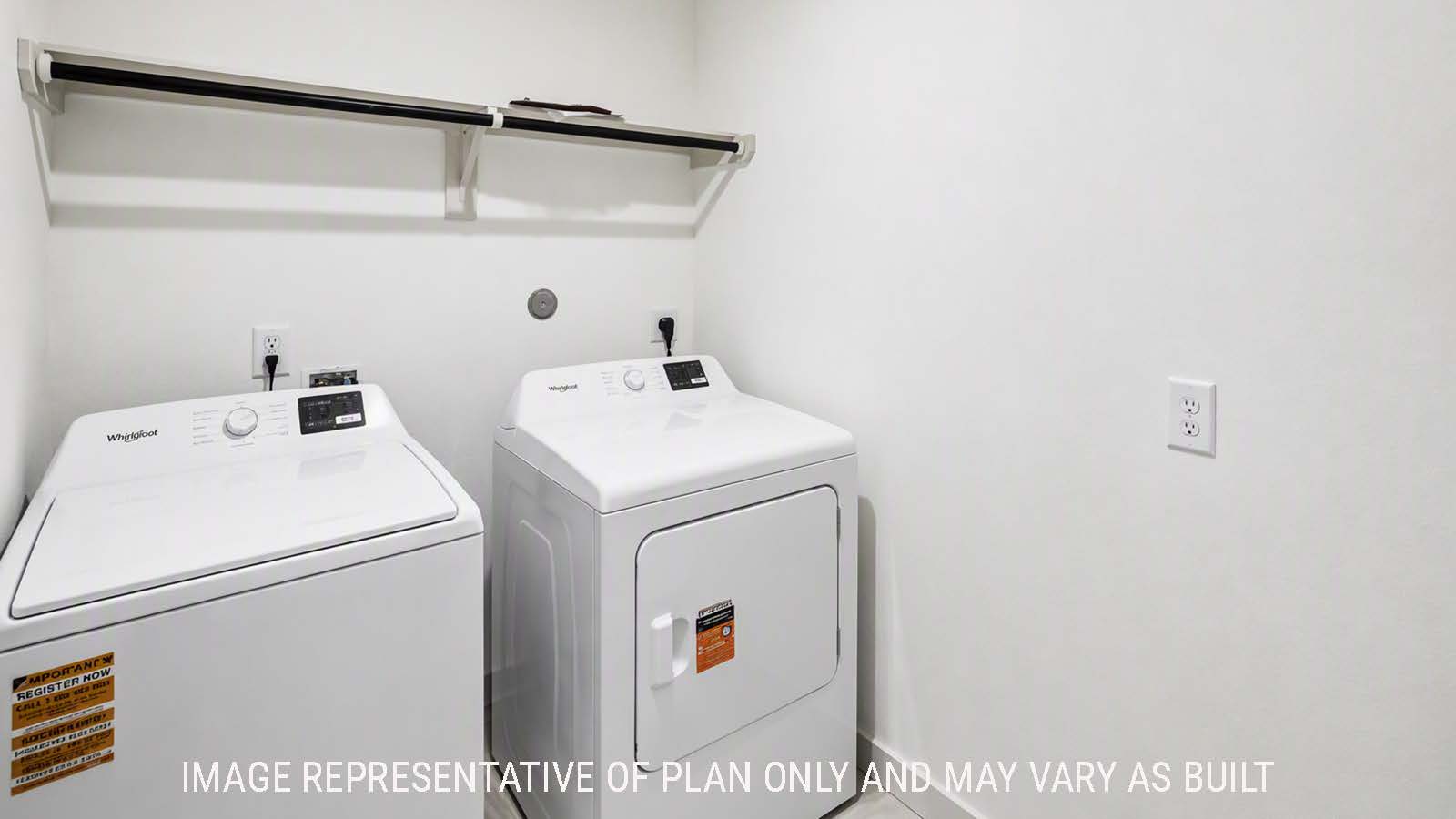 Denton utility room with washer and dryer and shelving for storage.
