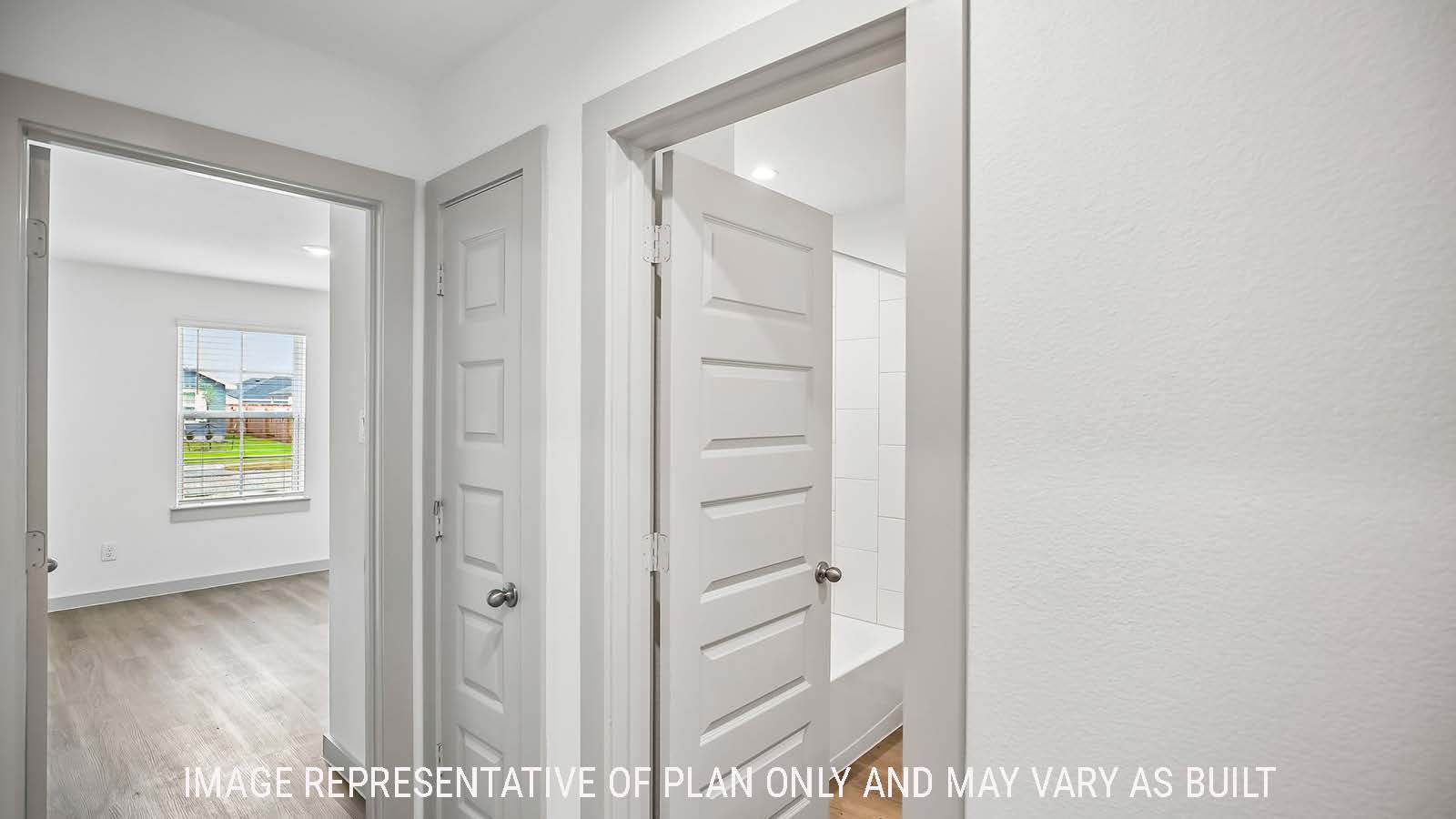 Denton entry way hallway with view of secondary bedroom and secondary bathroom.