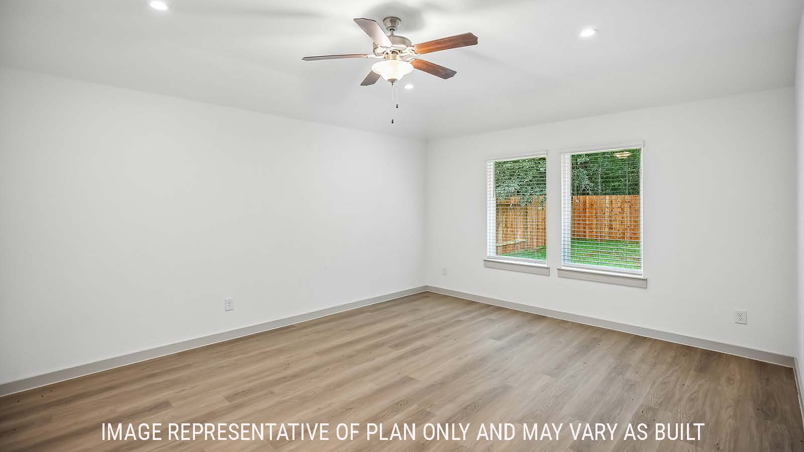 Denton living room with view of back yard and windows for natural lighting.