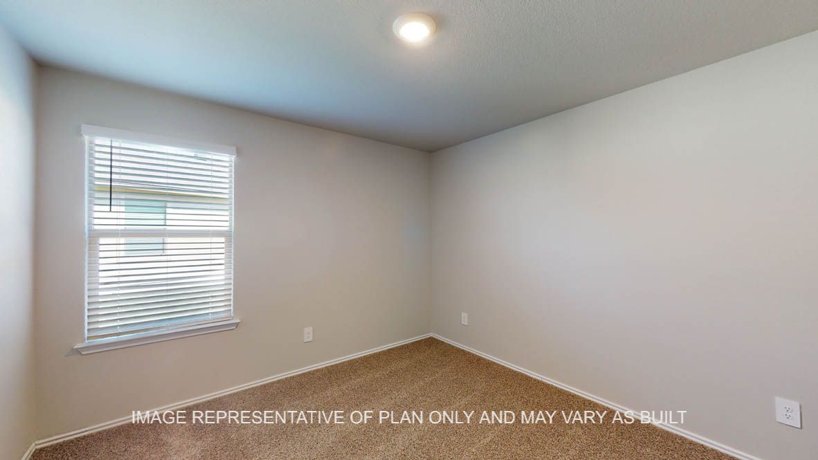 Kingston secondary bedroom with carpeted flooring and view of open concept kitchen.
