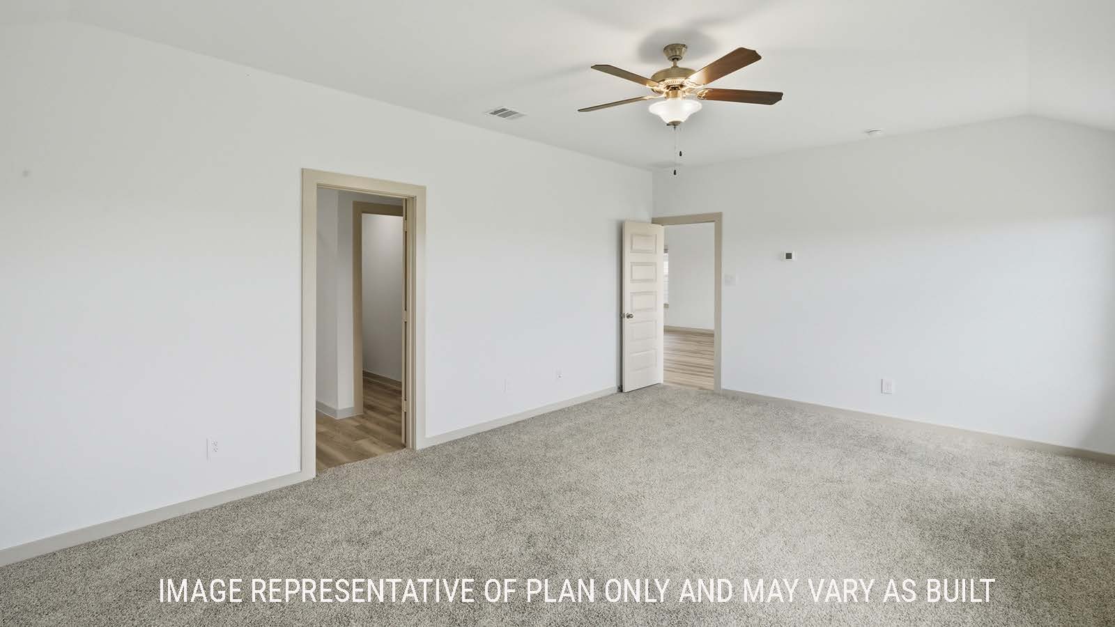 Kingston primary bedroom with carpeted flooring and view of primary bathroom.