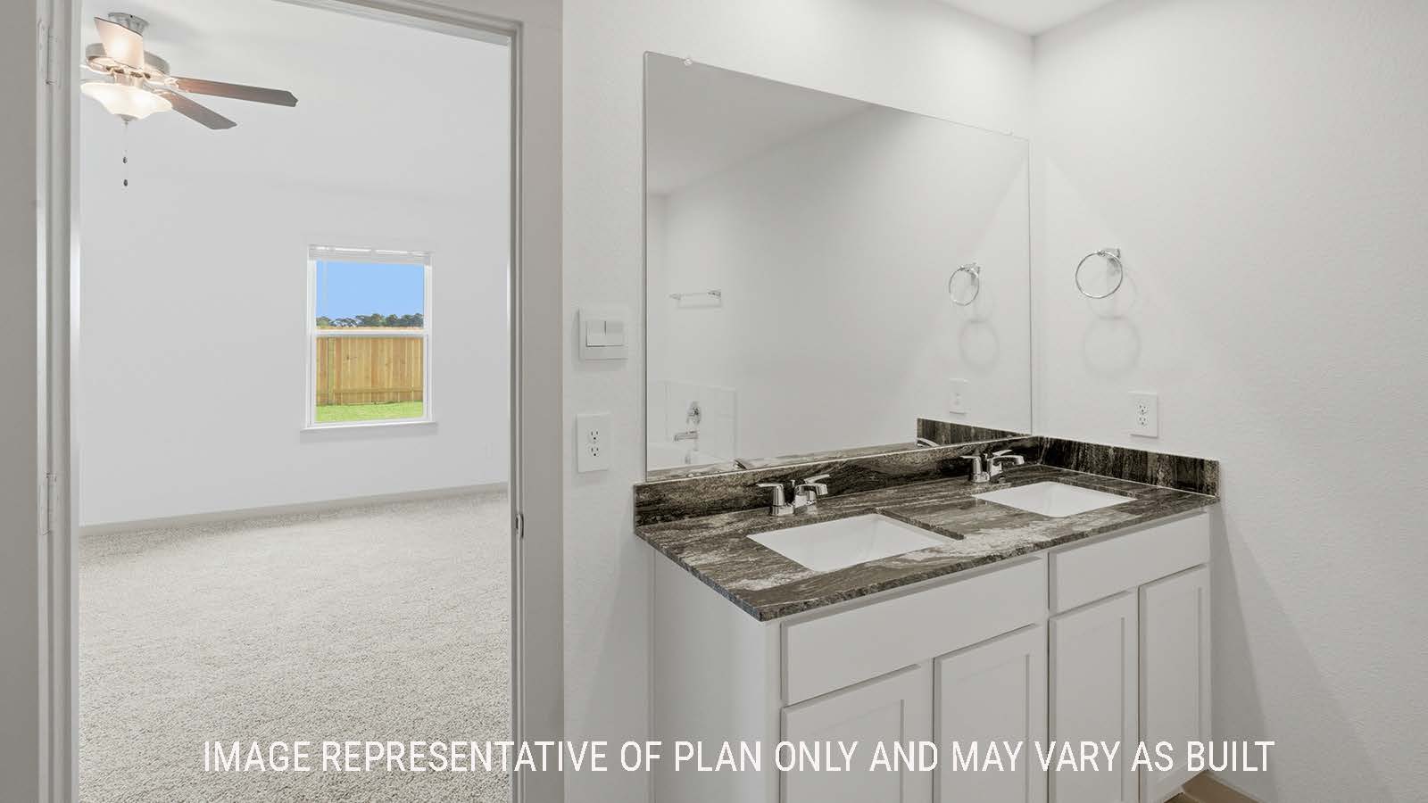 Kingston primary bathroom with double vanity sink and view of primary bedroom.