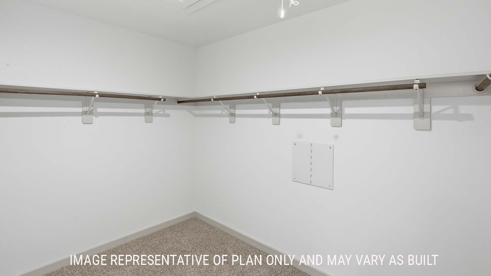 Kingston primary bedroom closet with carpeted flooring and shelving for storage.