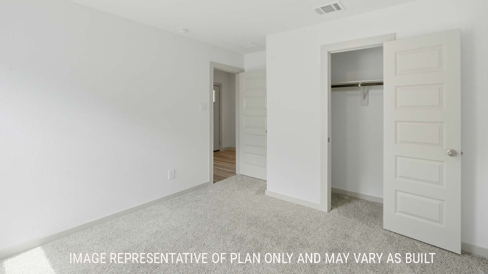 Kingston secondary bedroom with carpeted flooring and view of open concept kitchen.