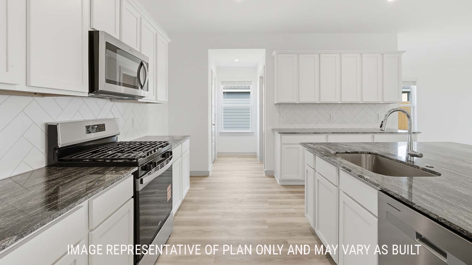 Kingston kitchen with white cabinets and granite countertops with window for natural lighting.