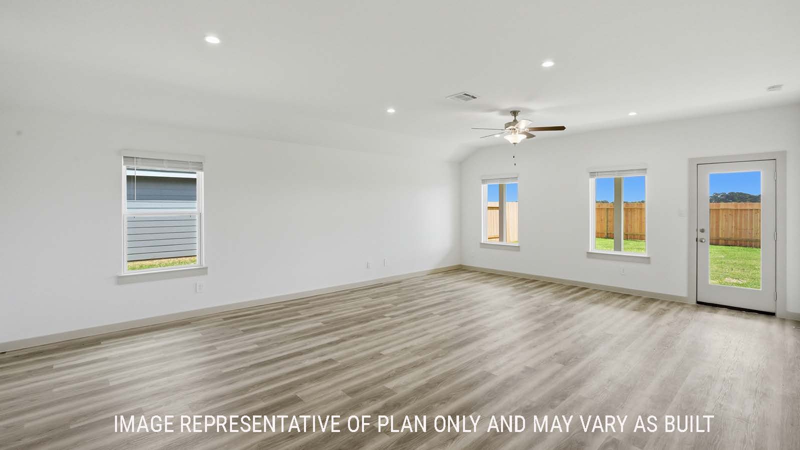 Kingston dining room with vinyl plank flooring and view of open concept living room and windows for natural lighting.