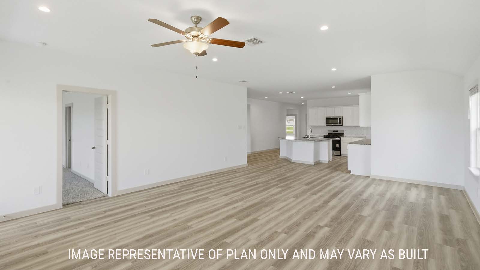 Kingston living room with vinyl plank flooring with view of open concept dining room and kitchen.