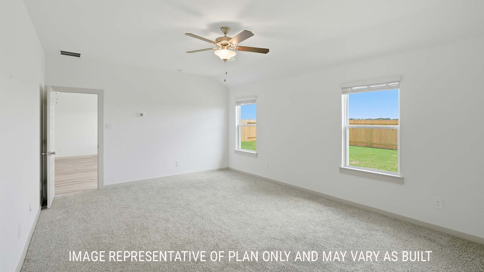 Kingston primary bedroom with carpeted flooring and windows for natural lighting.